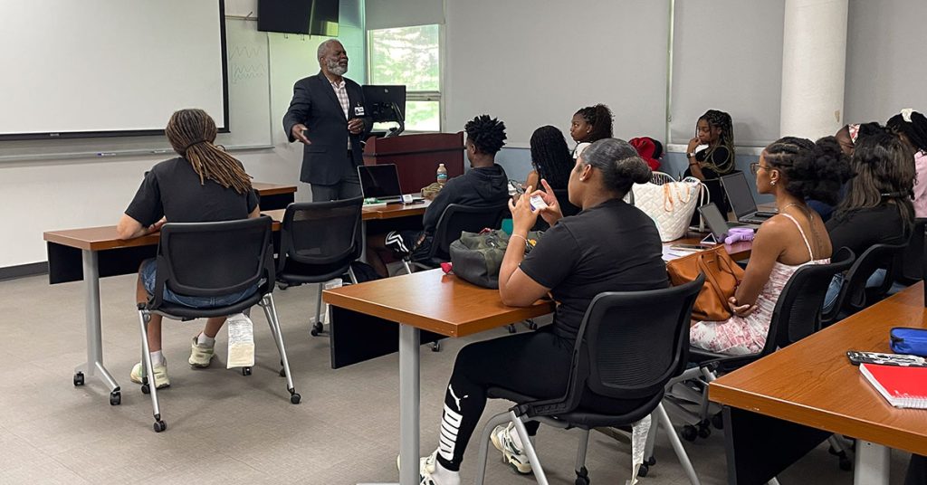 A guest speaker from Cook's Pest Control talks to students in classroom at FAMU.