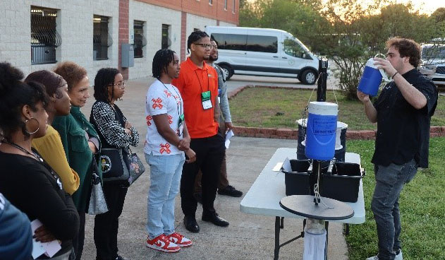 Pest Control Professional demonstrating the use of various mosquito traps to a group of students.