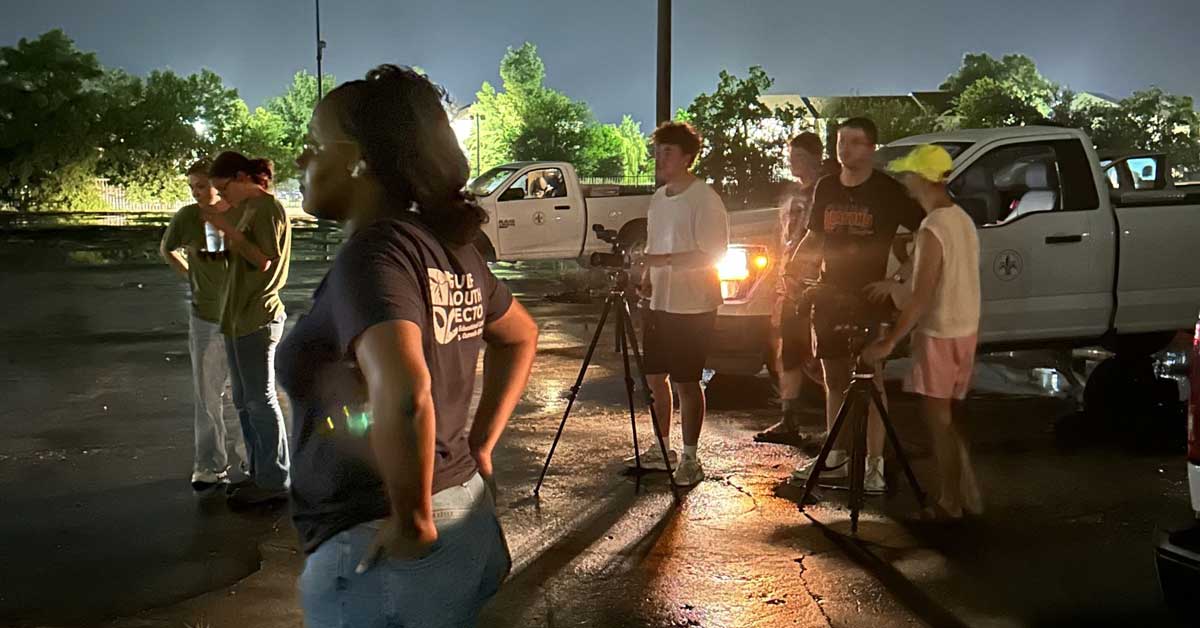 Image of students filming at night